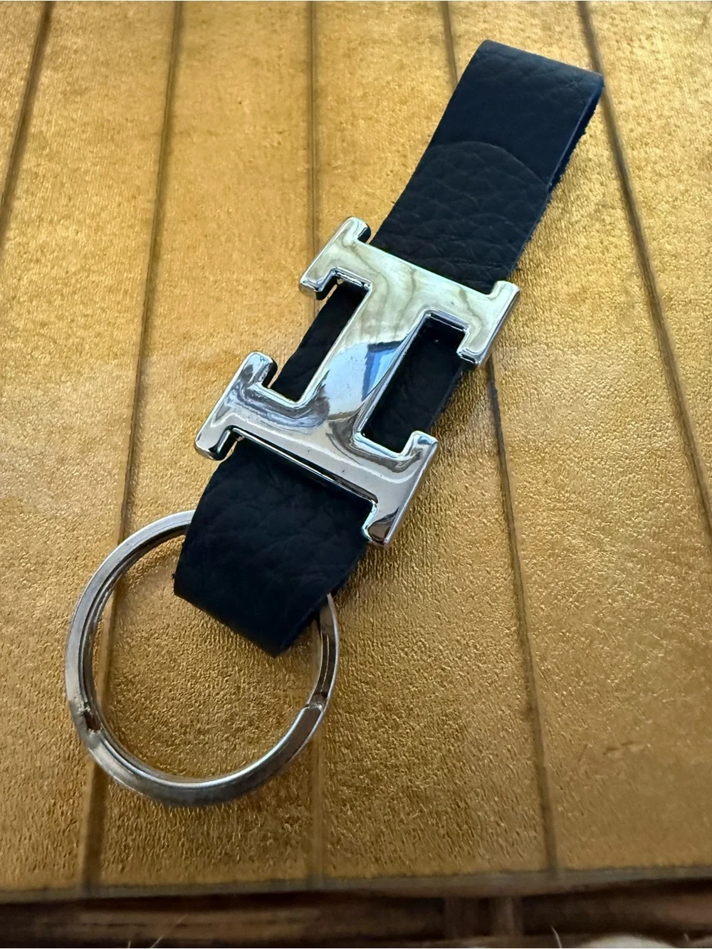 “H” chrome and black leather keychain